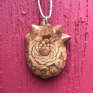 Beautiful handmade pine cone pendant. Hand sanded and made with care